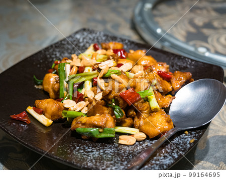 Kung Pao chicken on black plate 99164695