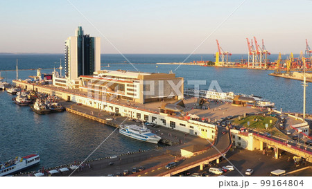 View from a drone flying over Hotel Odessa and Odesa port. Cruise and cargo ship harbour. 99164804