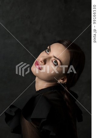 Beautiful woman with pigtails looks up Beautiful woman with pigtails looks up 99166530