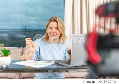 Middle aged woman making financial, investment or saving money content. Blogger creating content 99167712