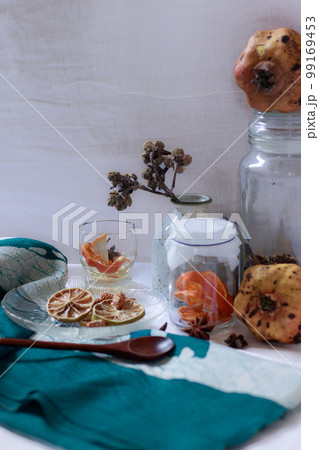 Vertical shot of pomegranate, lemon slices and aromatic herbs for a relaxing aromatherapy session at home 99169453