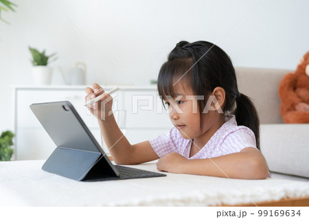 Education. Asian little girl learning and drawing with the online teacher on tablet digital Education. Asian little girl learning and drawing with the online teacher on tablet digital 99169634