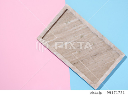 Empty beige rectangular marble plate on a blue pink background Empty beige rectangular marble plate on a blue pink background 99171721