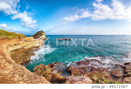 Picturesque seascape with white rocky cliffs, sea bay, islets and faraglioni near by beach Spiaggia della Punticeddha, Picturesque seascape with white rocky cliffs, sea bay, islets and faraglioni near by beach Spiaggia della Punticeddha, 99172307