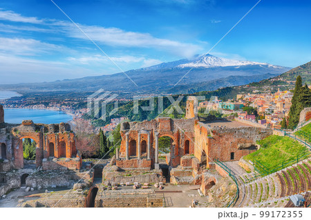 Ruins of ancient Greek theater in Taormina and Etna volcano in the background. 99172355