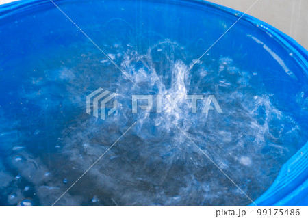 rainwater in a barrel in front of the house 99175486