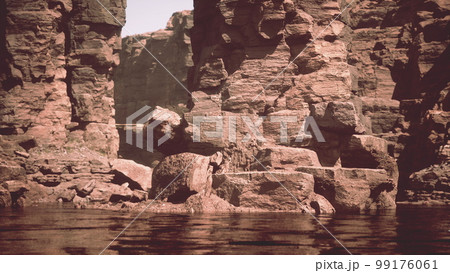 the river flowing through the valley of huge red rocks the river flowing through the valley of huge red rocks 99176061
