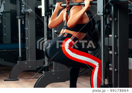 Slim girl working out in training apparatus Slim girl working out in training apparatus 99178664