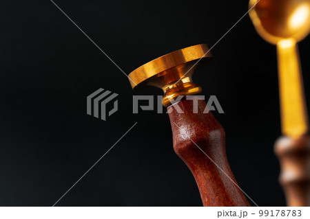 Wax seal stamp on dark black background 99178783