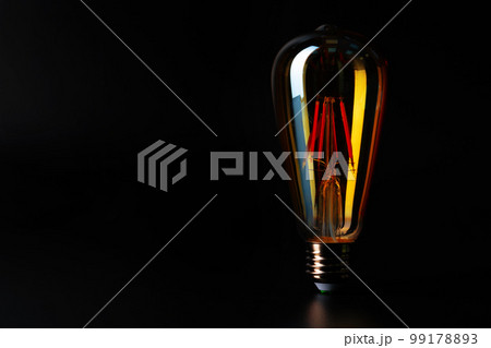 Light bulb on black background close up 99178893