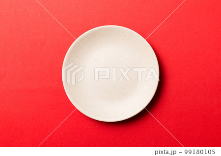 Top view of isolated of colored background empty round beige plate for food. Empty dish with space for your design Top view of isolated of colored background empty round beige plate for food. Empty dish with space for your design 99180105