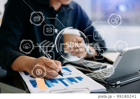 SDK Software development kit programming language technology concept, Person typing laptop computer and tablet with SDK icon on virtual screen. in office. SDK Software development kit programming language technology concept, Person typing laptop computer and tablet with SDK icon on virtual screen. in office. 99180241