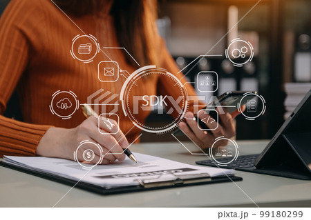 SDK Software development kit programming language technology concept, Person typing laptop computer and tablet with SDK icon on virtual screen. in office. SDK Software development kit programming language technology concept, Person typing laptop computer and tablet with SDK icon on virtual screen. in office. 99180299