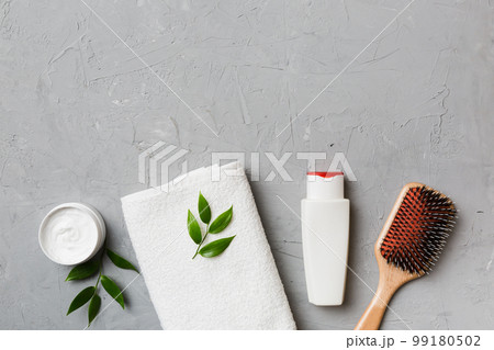 cosmetic for hair care, cream and towel on a colored background top view. flat lay cosmetic for hair care, cream and towel on a colored background top view. flat lay 99180502