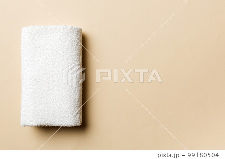 Top view of white towels with copy space on colored background Top view of white towels with copy space on colored background 99180504