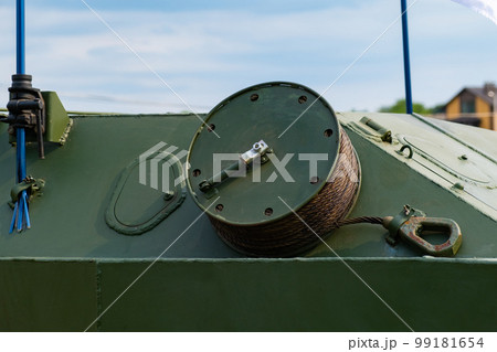 A drum with a wound cable on an armored personnel carrier in close-up. 99181654
