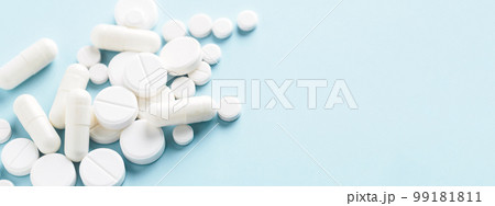 Various white pills on blue background. Banner for concept of medicine and pharmacy. Various white pills on blue background. Banner for concept of medicine and pharmacy. 99181811
