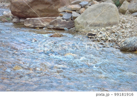 Rocky River mountain streams flowing through the rocks and pebbles of north east section of the Himalayan mountain ranges. Nature background. Close up. 99181916