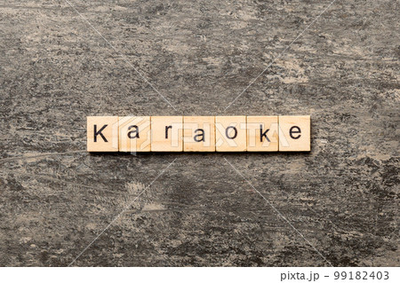 karaoke word written on wood block. karaoke text on table, concept 99182403