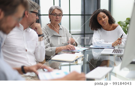 discussion of business people in the office sitting at the table 99184043