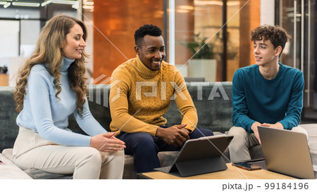 Multiracial group of people discussing business in an office Multiracial group of people discussing business in an office 99184196
