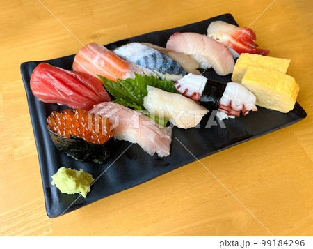 The premium Japanese sushi set place on black plate with wasabi 99184296