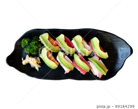 The premium Japanese avocado salmon roll on a black plate The premium Japanese avocado salmon roll on a black plate 99184299