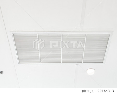 Ceiling mounted cassette type air conditioner and modern lamp light on white ceiling. duct air conditioner for home or office 99184313