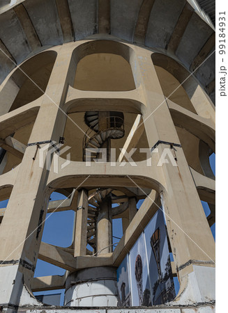 View of columnar structures old water tower made of cement and metal spiral staircase. View of columnar structures old water tower made of cement and metal spiral staircase. 99184931