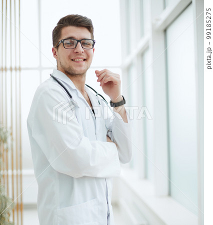handsome young doctor portrait in medical office 99185275