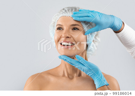 Middle aged woman in medical hat, ready for plastic surgery 99186014