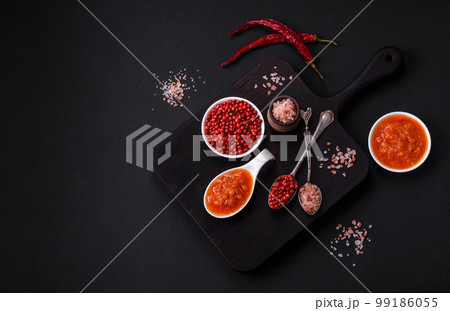 Red adjika sauce or ketchup with spices and herbs 99186055