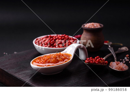 Red adjika sauce or ketchup with spices and herbs Red adjika sauce or ketchup with spices and herbs 99186058