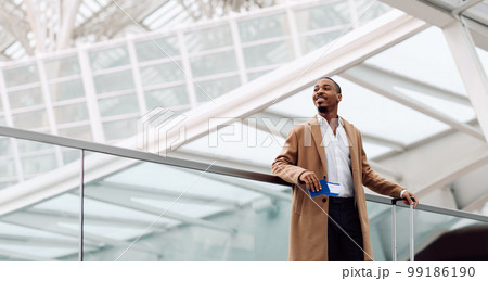 Smiling Black Male Traveller Standing With Suitcase At Airport 99186190