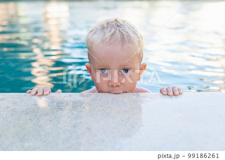 Photo of active baby in swimming pool 99186261