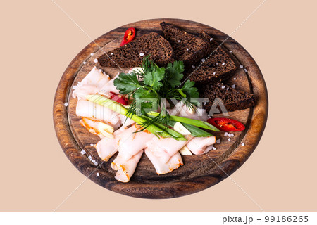 Lard slice black bread and greens on a wooden board on a isolated background top view 99186265