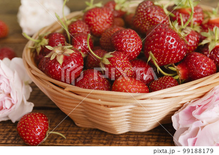 Ripe garden strawberry in bowl on wooden table 99188179
