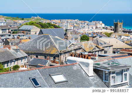 View of rooftops in St Ives, west Cornwall, South West England. Beautiful blue sea on the background. Selective focus View of rooftops in St Ives, west Cornwall, South West England. Beautiful blue sea on the background. Selective focus 99188857