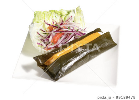 Peruvian traditional food. Tamal with a green salad 99189479