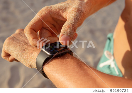 a man checks his pulse after training 99190722