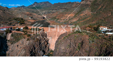 Artificial lake water dam in the Canary Islands at Gran Canaria. Aerial view of the Dam holding the water. 99193822