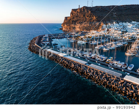 Puerto de Mogan fishing town aerial view at sunset. Traditional colorful buildings with many fishing boats at Gran Canaria, Canary Islands, Spain 99193942
