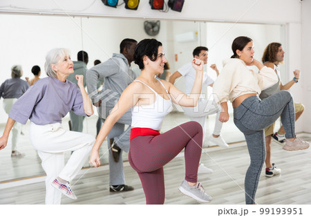 Group of people of different nationalities learn sports dance Group of people of different nationalities learn sports dance 99193951