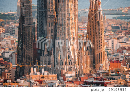 Beautiful aerial view of the Barcelona city with a Sagrada Familia cathedral standing in the city center. Beautiful aerial view of the Barcelona city with a Sagrada Familia cathedral standing in the city center. 99193955