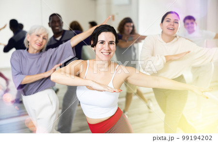 Group of dancing people practicing energetic swing 99194202