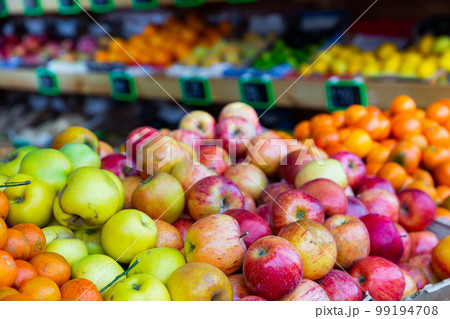 Bunches of fruits on shelves in greengrocer 99194708