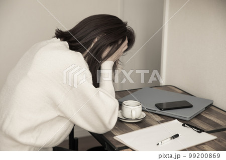 デスクで頭を抱える女性　trouble 99200869