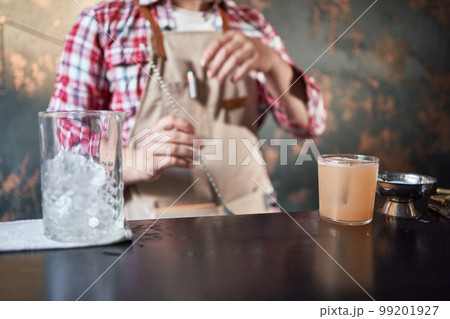 bartender mixing a cocktail at the bar. bartender mixing a cocktail at the bar. 99201927