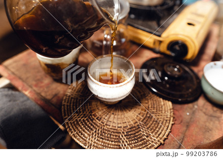 Man pouring hot water on ground coffee with paper filter to making a drip coffee 99203786