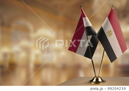 Small flags of the Egypt on an abstract blurry background Small flags of the Egypt on an abstract blurry background 99204239